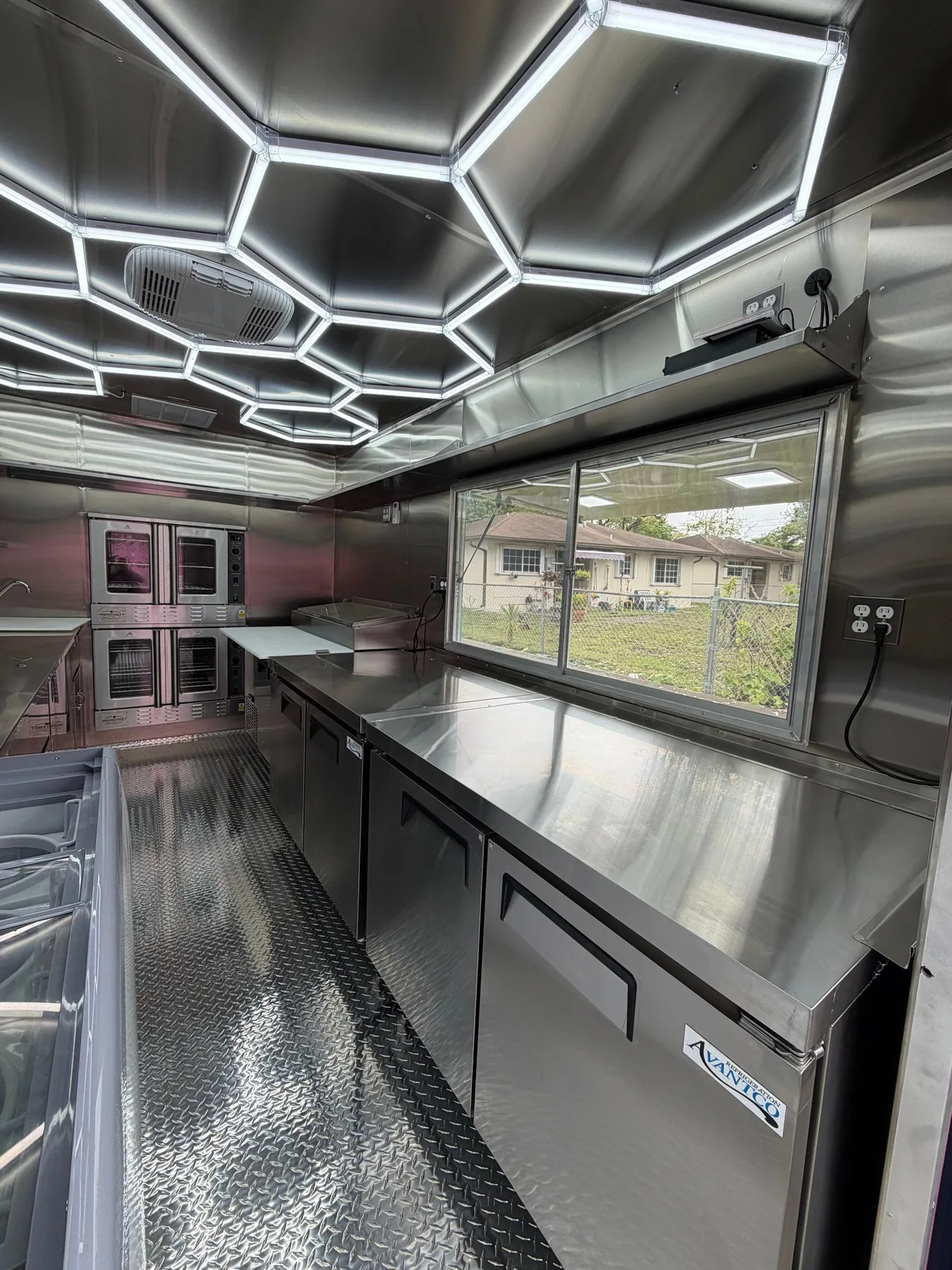 Inside the Miami Pizza food truck showing the cooking and service window area